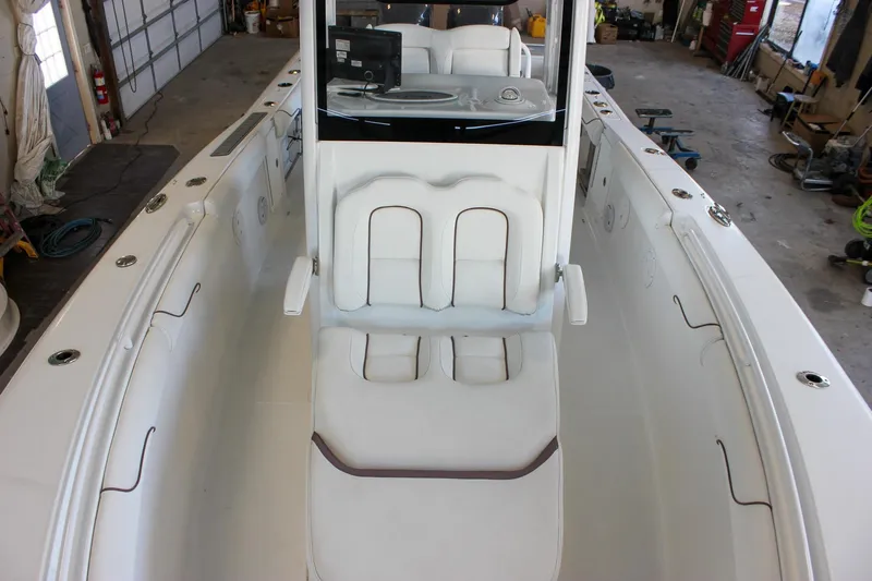  Yacht Photos Pics 2018 Sea Hunt Gamefish 30 boat interior with white seating in a garage setting.