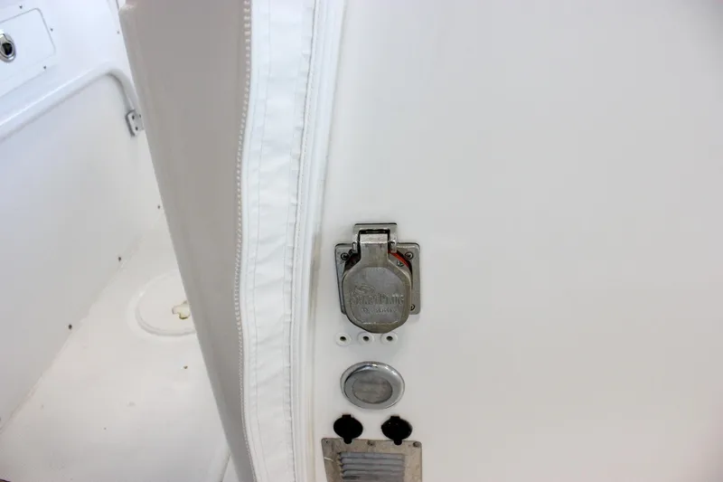  Yacht Photos Pics 2018 Sea Hunt Gamefish 30 boat interior detail with metal latch and white upholstery.