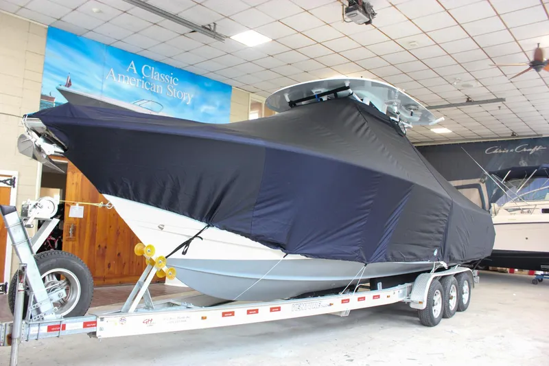 Yacht Photos Pics 2018 Sea Hunt Gamefish 30 boat covered on trailer in indoor showroom.