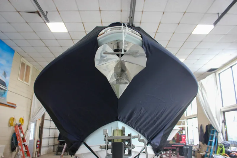  Yacht Photos Pics 2018 Sea Hunt Gamefish 30 boat covered in a protective tarp inside a workshop.