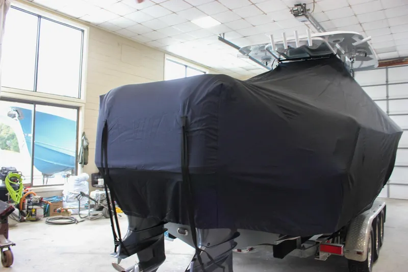  Yacht Photos Pics 2018 Sea Hunt Gamefish 30 boat covered in black tarp inside a garage.
