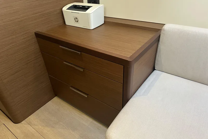  Yacht Photos Pics Wooden cabinet with printer and sofa in Lagoon 46 yacht interior, 2022 model.