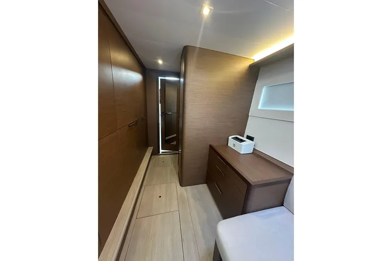  Yacht Photos Pics Interior of 2022 Lagoon 46 yacht, featuring modern wood cabinetry and sleek design.