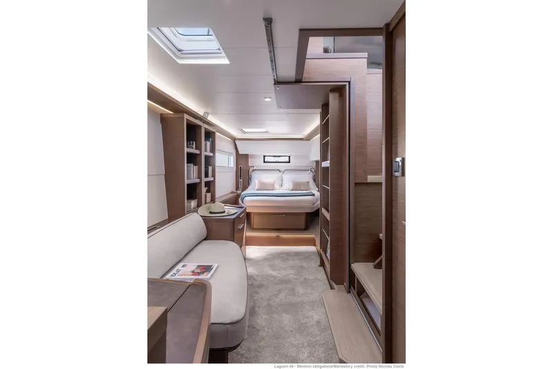  Yacht Photos Pics Luxurious interior of 2022 Lagoon 46 yacht featuring cozy bedroom and elegant furnishings.
