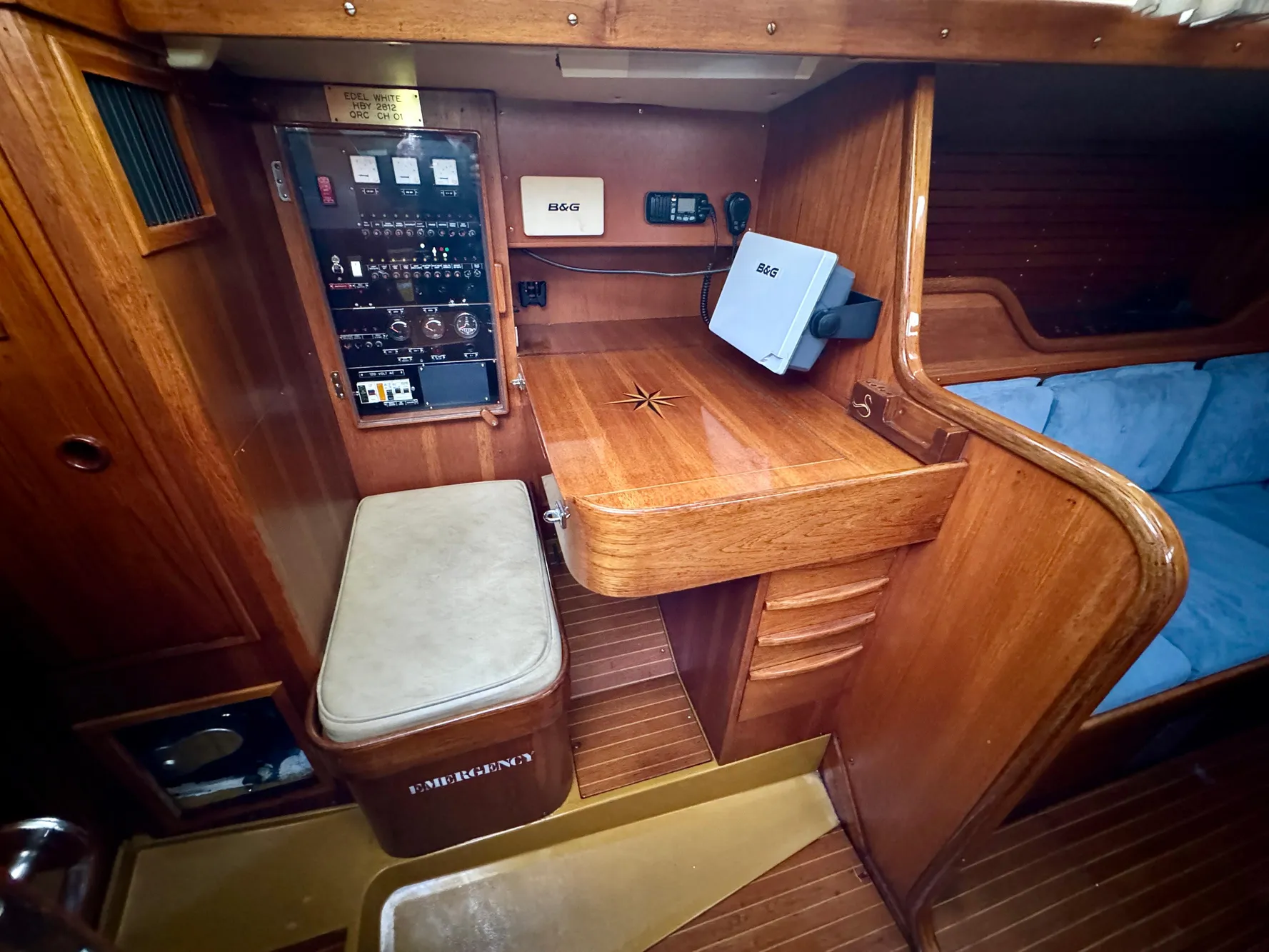 1974 Nautor Swan 38 yacht interior with navigation station and wooden cabinetry.