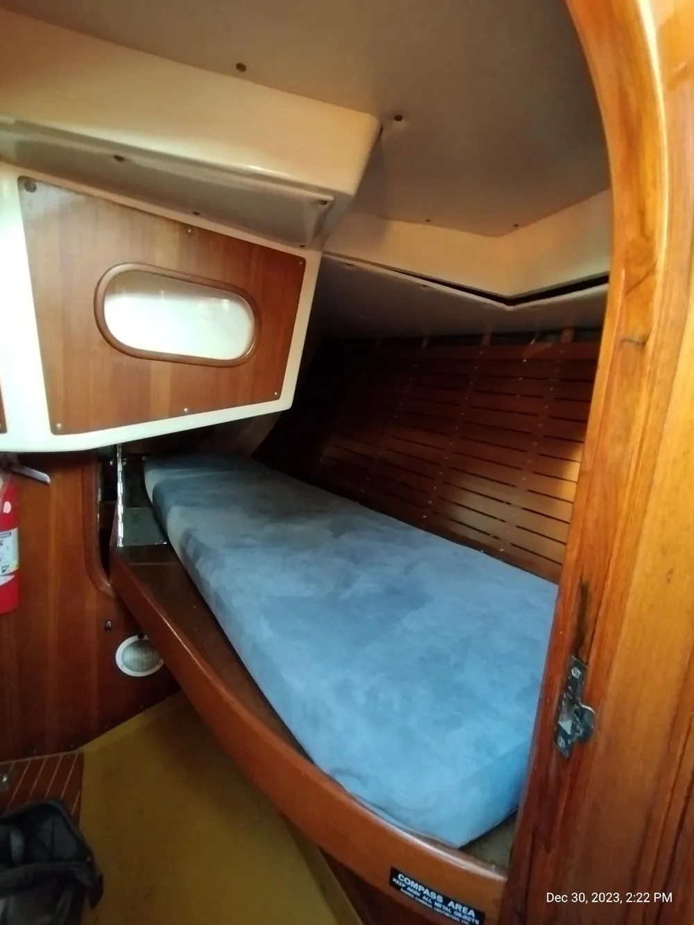 1974 Nautor Swan 38 cabin interior with wooden finish and blue mattress.