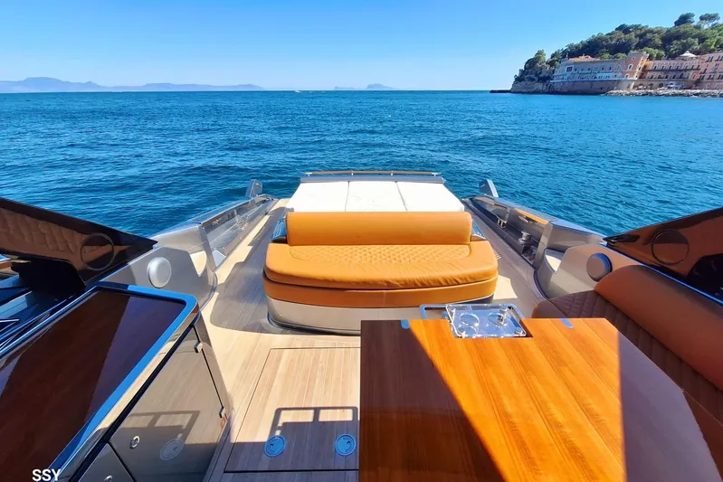 Yacht Photos Pics Luxurious 2022 Riva RIVALE 56 HT yacht with elegant deck seating, cruising on serene blue waters.