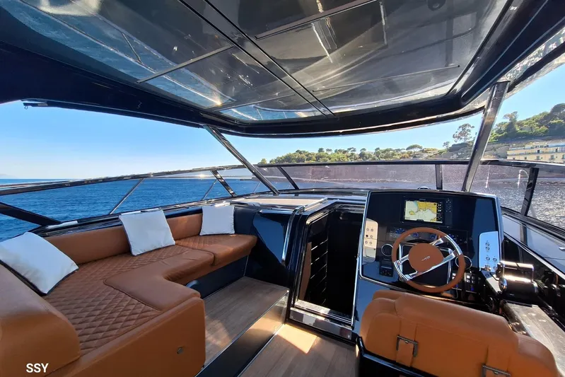  Yacht Photos Pics Luxurious interior of 2022 Riva RIVALE 56 HT yacht with leather seating and modern helm.