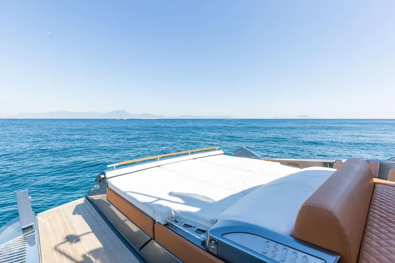  Yacht Photos Pics Luxurious 2022 Riva RIVALE 56 HT yacht with sunbed, overlooking serene ocean view.