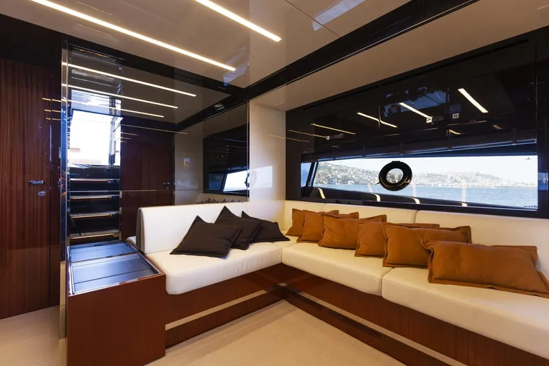 Yacht Photos Pics Luxurious interior of 2022 Riva RIVALE 56 HT yacht with elegant seating and scenic window view.