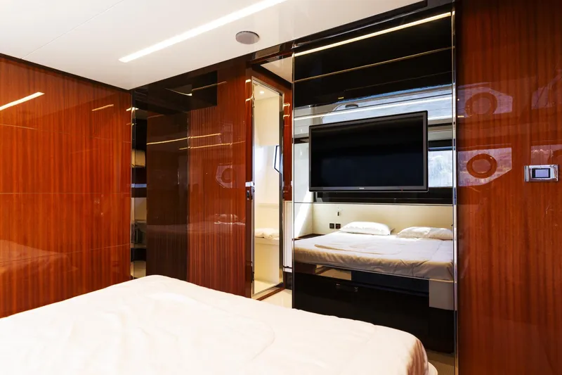  Yacht Photos Pics Luxurious interior of 2022 Riva RIVALE 56 HT yacht with modern wood paneling and TV.