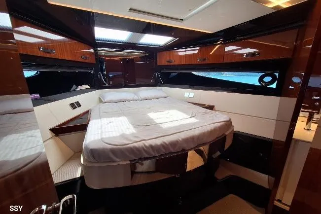  Yacht Photos Pics Luxurious interior cabin of 2022 Riva RIVALE 56 HT yacht with elegant wood finishes.
