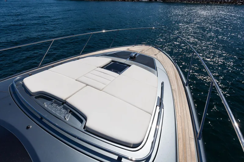 Yacht Photos Pics Luxury Riva RIVALE 56 HT yacht deck with sunbed, 2022 model, on sparkling water.