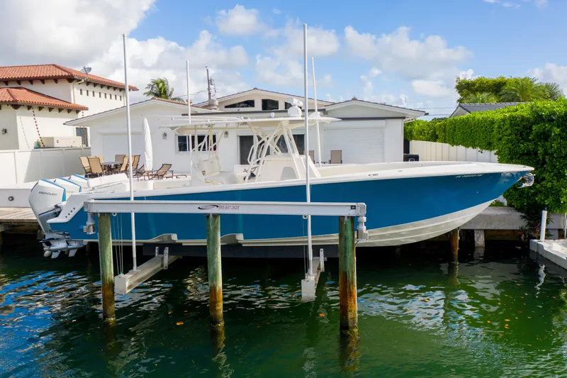 Seavee Yacht Photos Pics 2023 SeaVee 370z boat docked at a waterfront property under a clear blue sky.