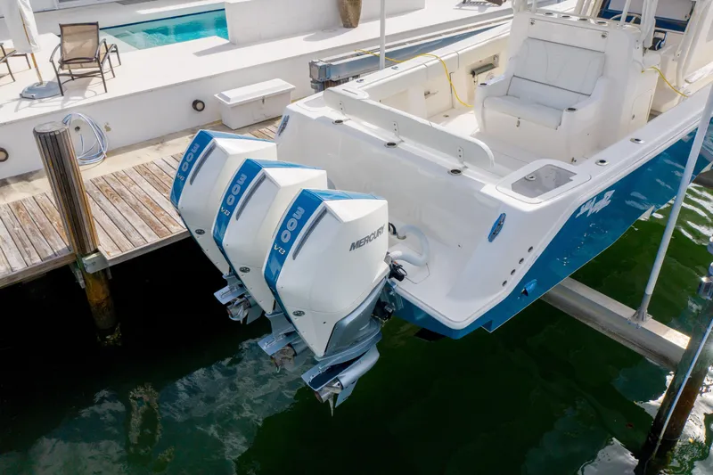 Seavee Yacht Photos Pics 2023 SeaVee 370z boat with twin Mercury 400 outboard engines docked by a poolside.