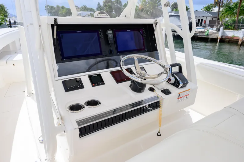 Seavee Yacht Photos Pics 2023 SeaVee 370z boat console with dual screens and steering wheel.