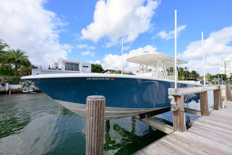 Seavee Yacht Photos Pics 2023 SeaVee 370z boat docked, featuring sleek blue hull and modern design.