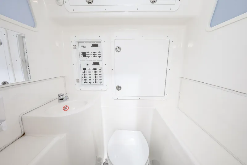 Seavee Yacht Photos Pics 2023 SeaVee 370z boat interior with control panel and compact bathroom.