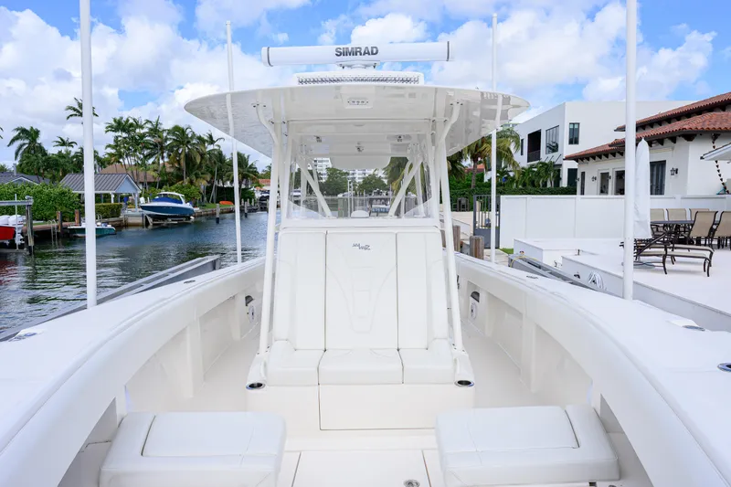 Seavee Yacht Photos Pics 2023 SeaVee 370z boat docked in a scenic waterfront setting.