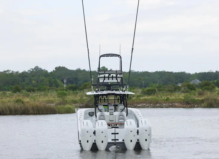 Brand New Yacht Photos Pics 2025 Freeman 42 LR boat on calm water, surrounded by lush greenery.