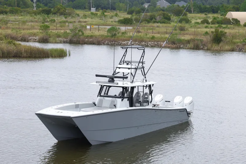 Brand New Yacht Photos Pics 2025 Freeman 42 LR boat with fishing rods on a calm river.