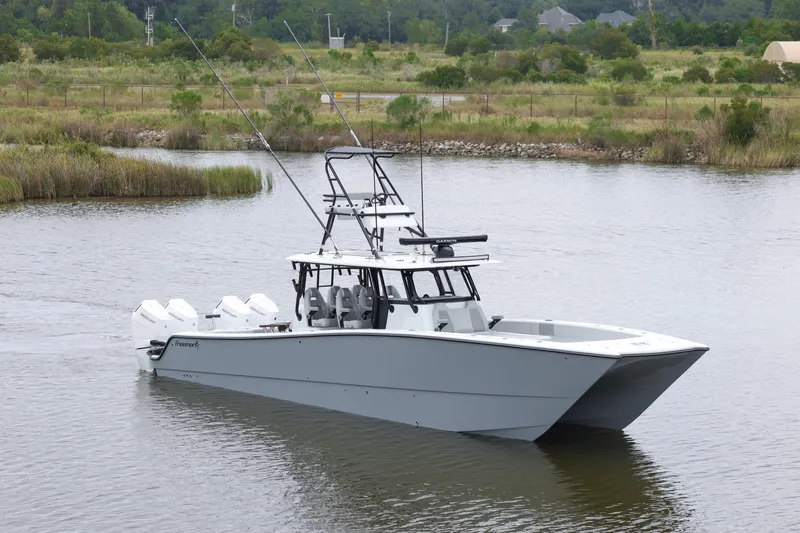 Brand New Yacht Photos Pics 2025 Freeman 42 LR boat on calm water, featuring multiple outboard engines.