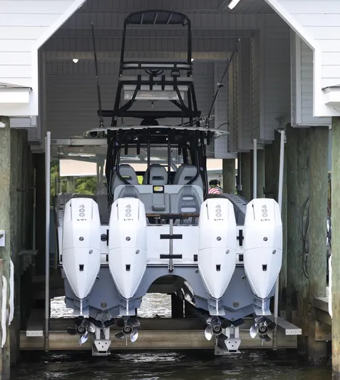 Brand New Yacht Photos Pics Freeman 42 LR 2025 boat with four engines in a boathouse lift.