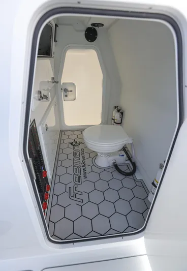 Brand New Yacht Photos Pics Interior of Freeman 42 LR 2025 boat, featuring a compact bathroom with hexagonal flooring.