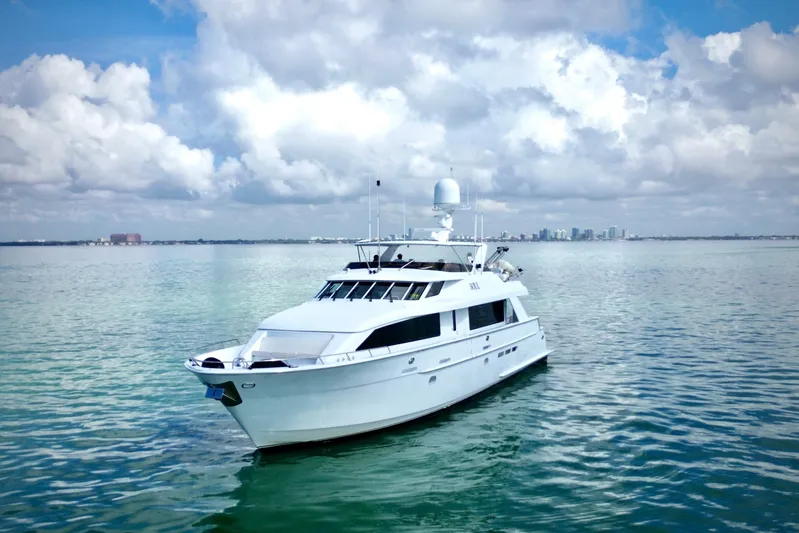 Soul Yacht Photos Pics 2002 Hatteras 92 Cockpit Motor Yacht on calm waters under cloudy sky.