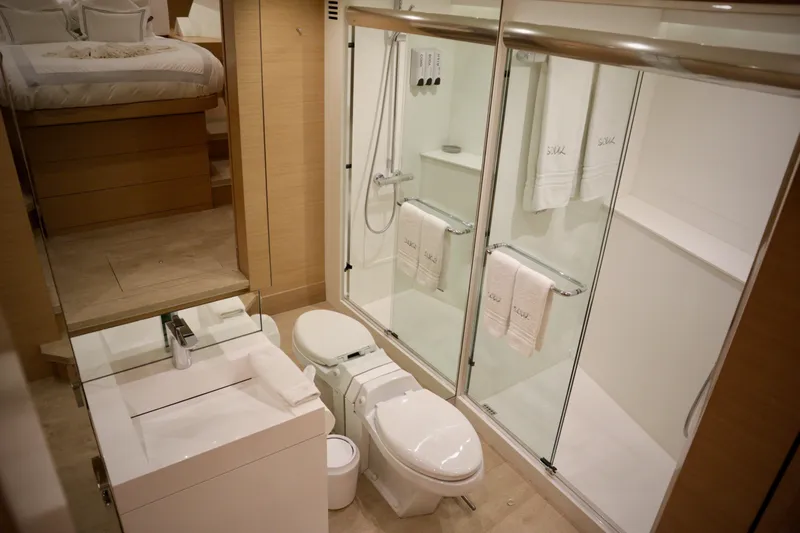 Soul Yacht Photos Pics Luxurious bathroom in 2002 Hatteras 92 Cockpit Motor Yacht with modern amenities and elegant design.