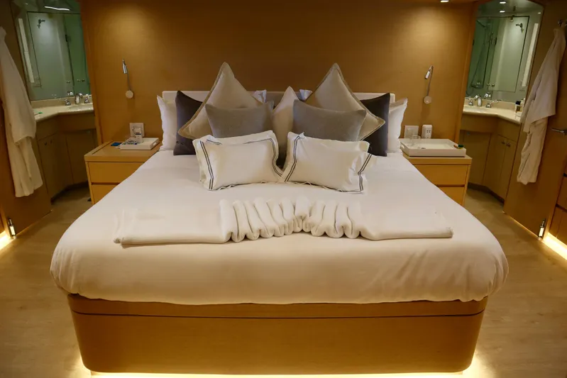 Soul Yacht Photos Pics Luxurious bedroom interior on 2002 Hatteras 92 Cockpit Motor Yacht, featuring elegant bedding and ambient lighting.