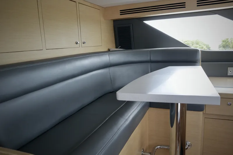 Soul Yacht Photos Pics Luxurious interior of 2002 Hatteras 92 Cockpit Motor Yacht with sleek seating and modern table.