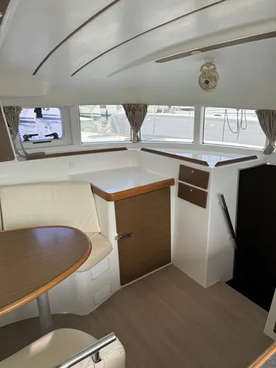 Oscar III Yacht Photos Pics Interior of 2018 Lagoon LAGOON 380 catamaran with seating area and windows.
