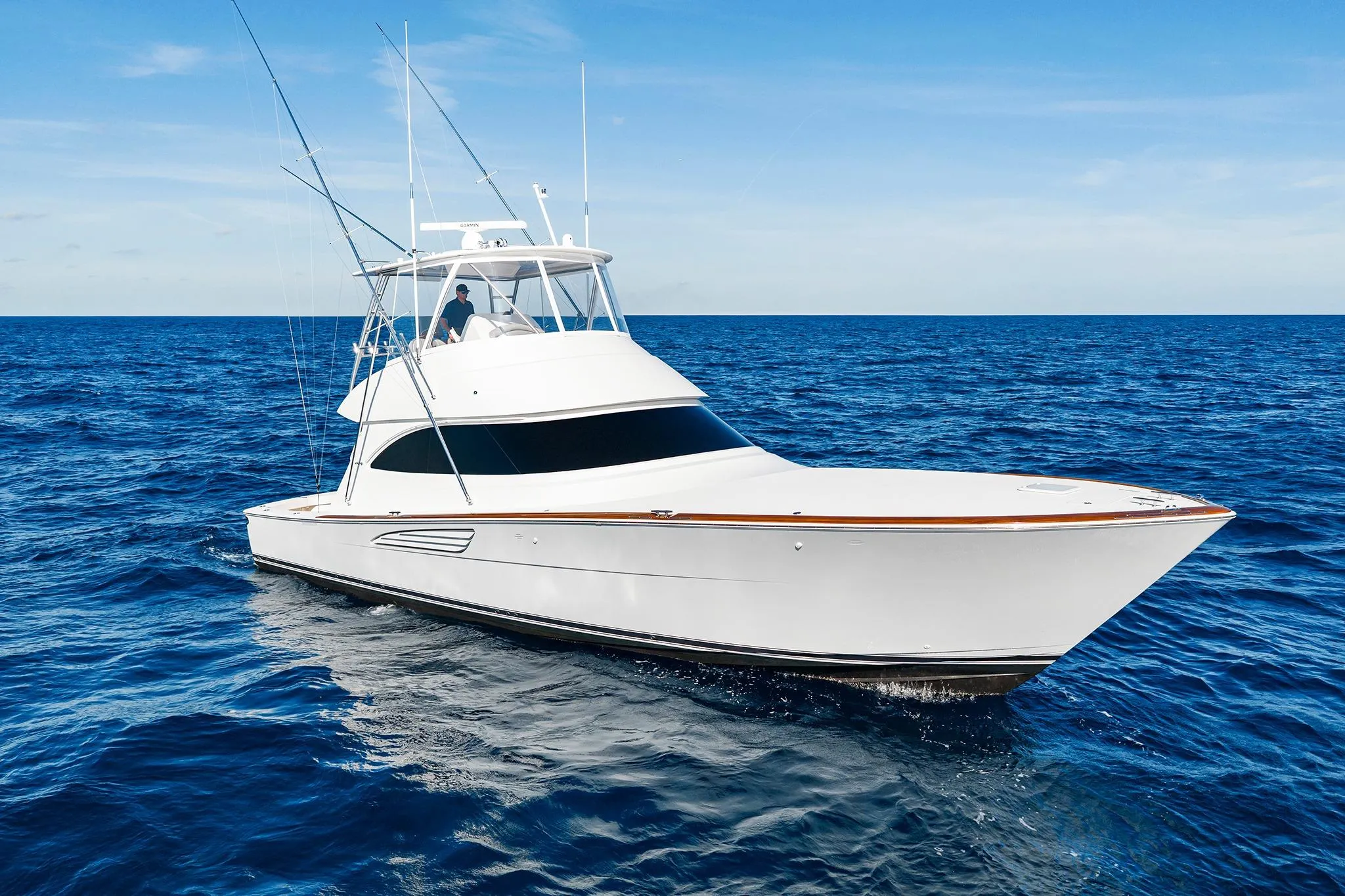 2026 Viking 50 Convertible yacht cruising on open ocean under clear blue sky.