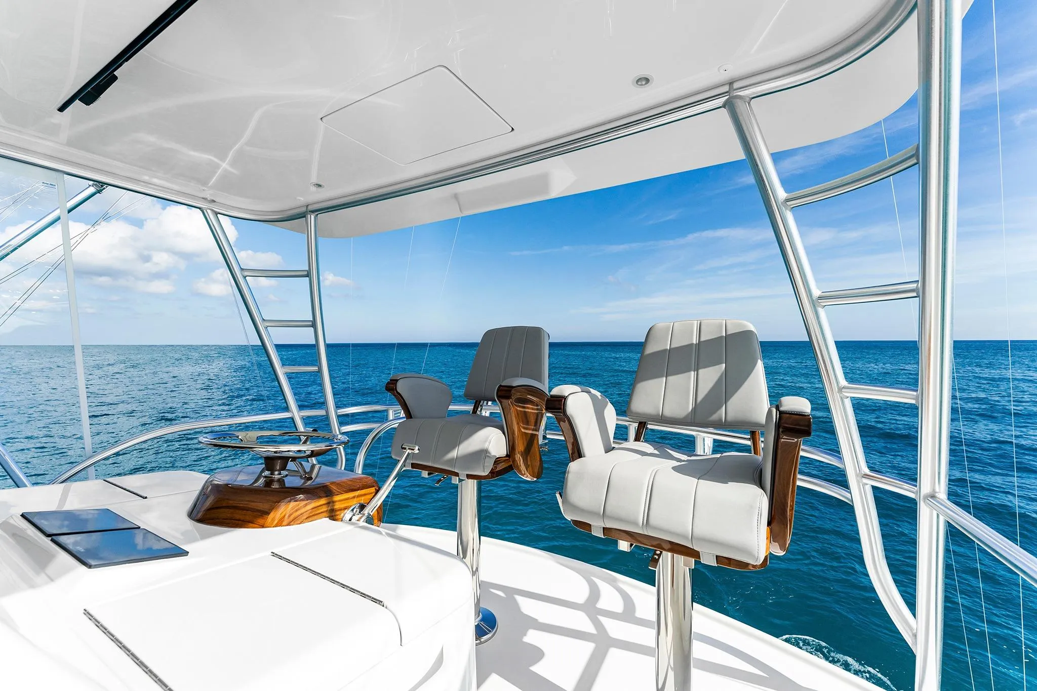 Flybridge of 2026 Viking 50 Convertible yacht with ocean view and seating.