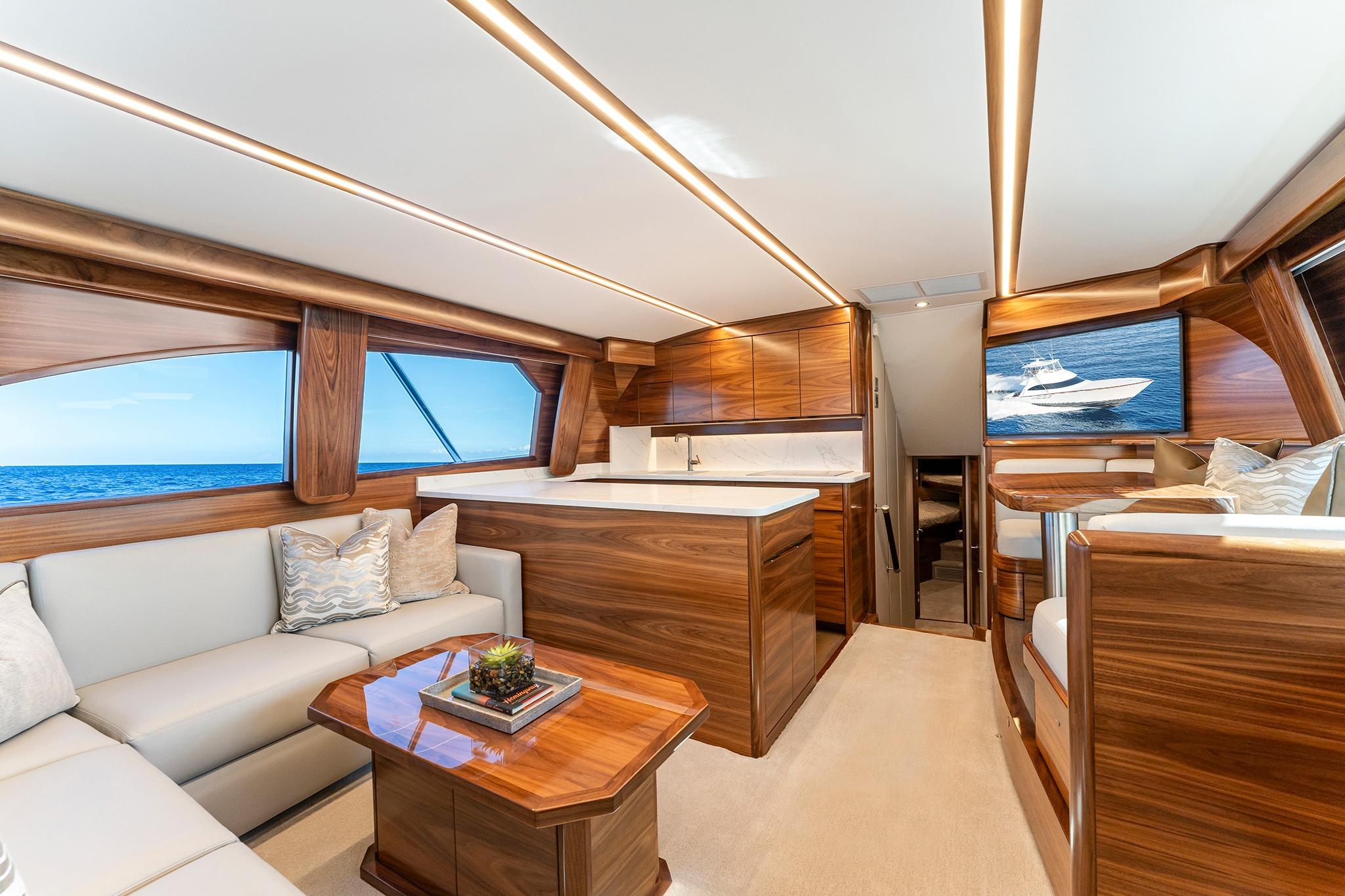 Luxurious interior of 2026 Viking 50 Convertible yacht with elegant wood finishes and ocean view.