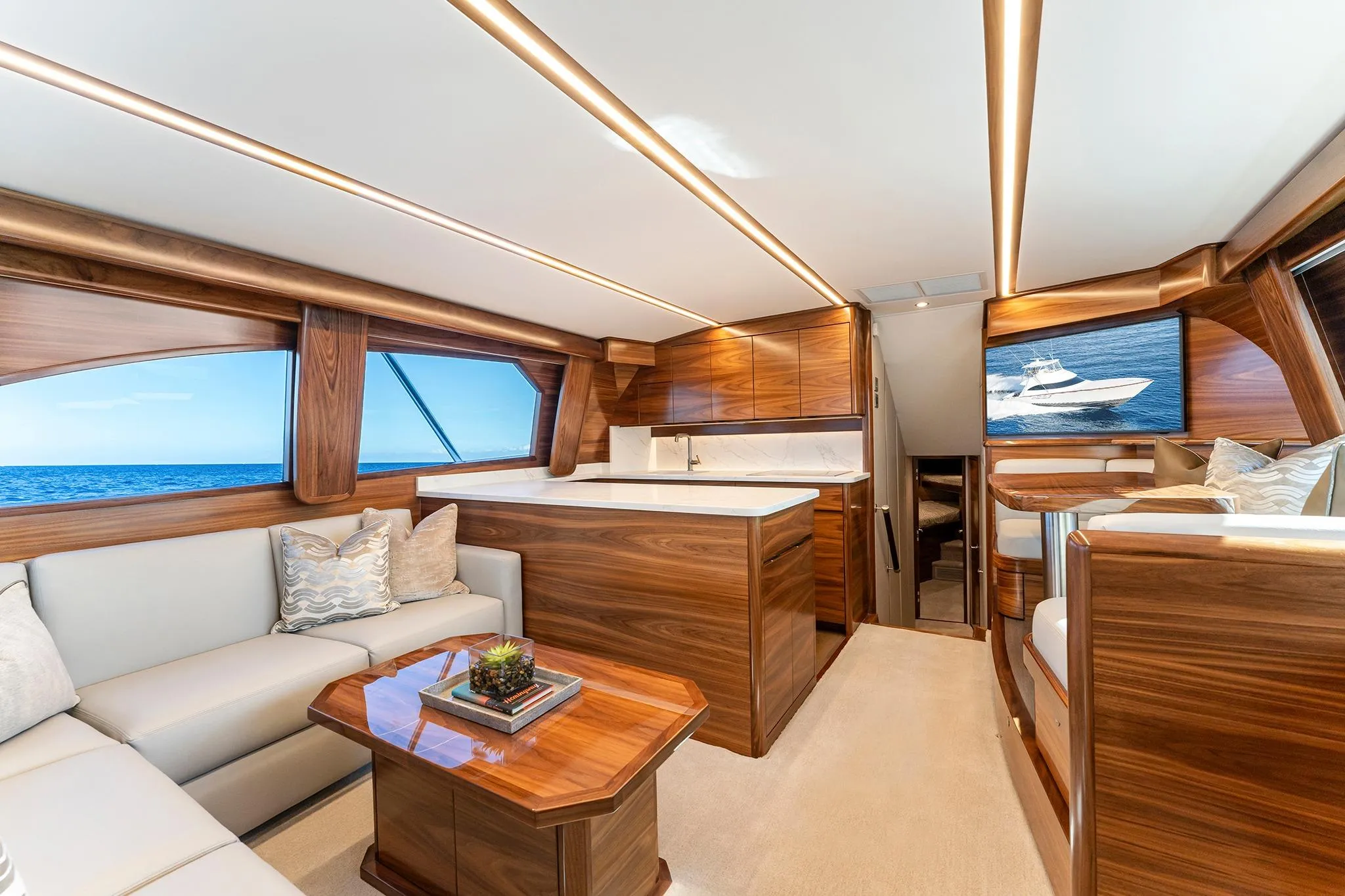Luxurious interior of 2026 Viking 50 Convertible yacht with elegant wood finishes and ocean view.