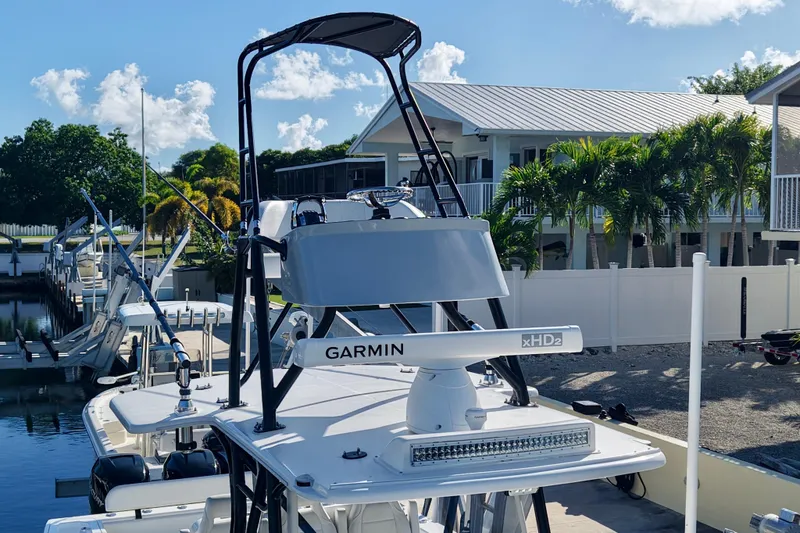  Yacht Photos Pics 2019 SeaVee 370Z boat with Garmin radar, docked near palm trees and houses.