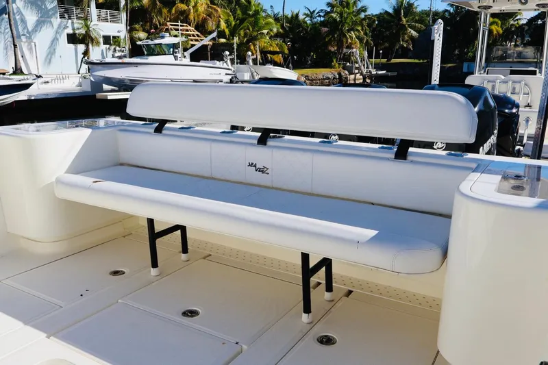  Yacht Photos Pics 2019 SeaVee 370Z boat with white seating, docked near palm trees.