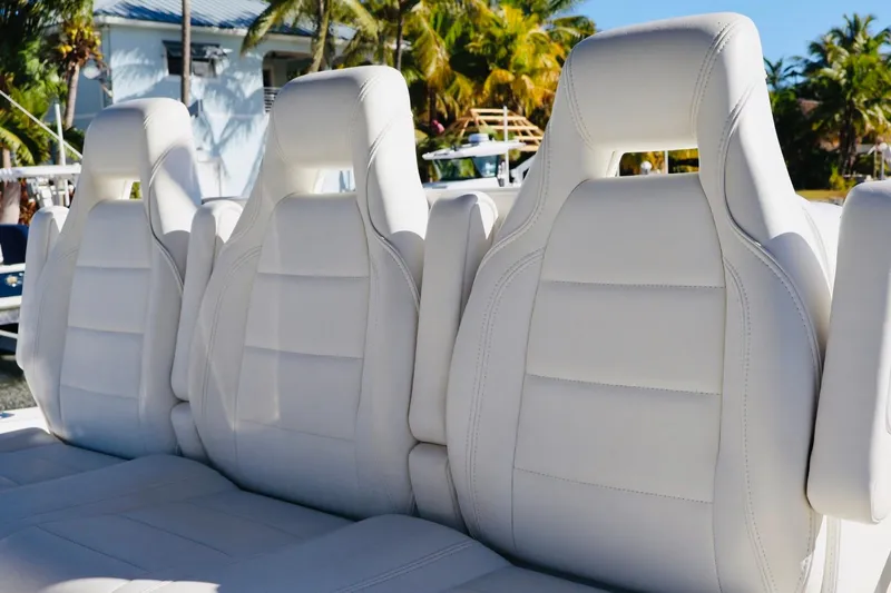  Yacht Photos Pics White leather seats on a 2019 SeaVee 370Z boat, surrounded by tropical scenery.