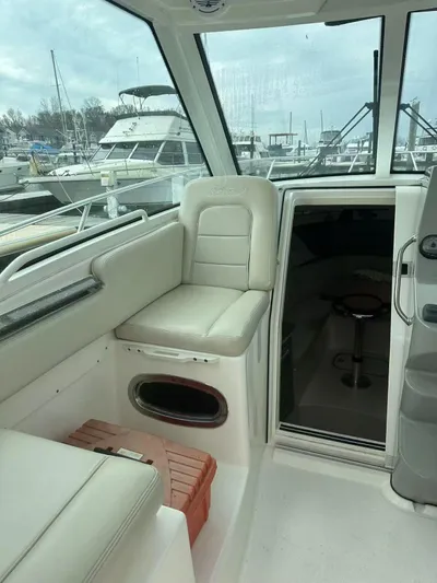  Yacht Photos Pics 2016 Boston Whaler 285 Conquest interior with seating and cabin entrance.