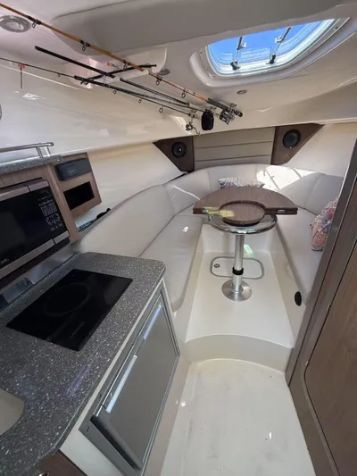  Yacht Photos Pics Interior of 2016 Boston Whaler 285 Conquest boat with kitchenette and seating area.