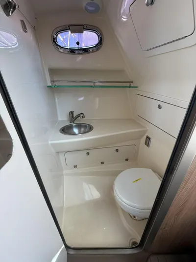  Yacht Photos Pics 2016 Boston Whaler 285 Conquest bathroom with sink, toilet, and storage.