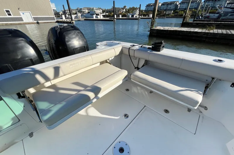  Yacht Photos Pics 2016 Boston Whaler 285 Conquest boat interior with seating and dual engines at a marina.