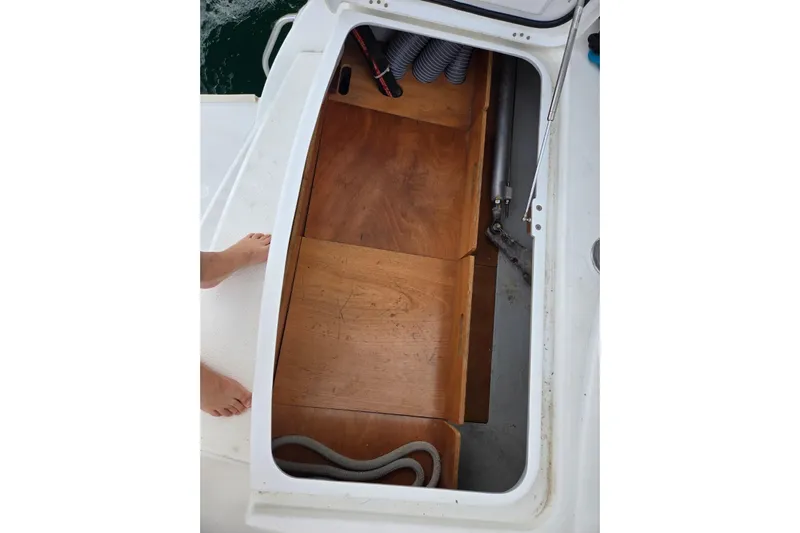Arias Song Yacht Photos Pics Open storage compartment on 2016 Lagoon 400 S2 catamaran with wooden flooring and coiled rope.