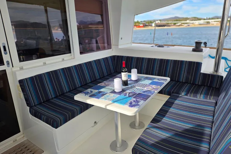 Arias Song Yacht Photos Pics Interior of 2016 Lagoon 400 S2 yacht with striped seating and table setting.