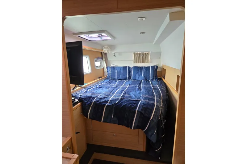 Arias Song Yacht Photos Pics Interior cabin of 2016 Lagoon 400 S2 yacht with blue bedding and natural light.