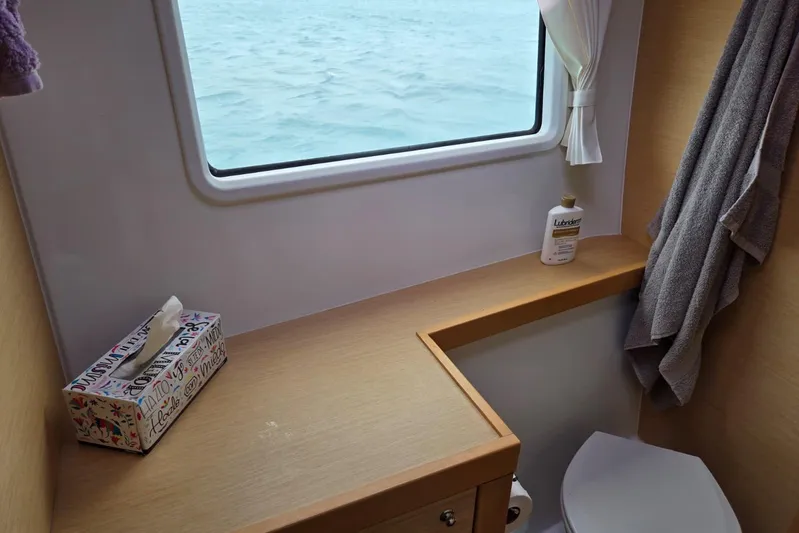 Arias Song Yacht Photos Pics Bathroom interior of 2016 Lagoon 400 S2 yacht with ocean view window.