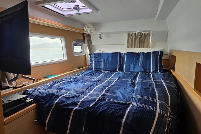 Arias Song Yacht Photos Pics Interior cabin of 2016 Lagoon 400 S2 catamaran with blue bedding and window view.