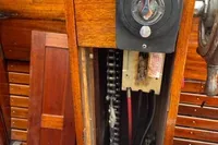 1926 custom motorboat interior with wooden paneling and mechanical components.